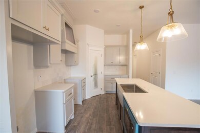 Kitchen featuring cooktop, dark hardwood / wood-st