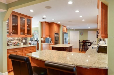 Kitchen features granite counters plus glass door 