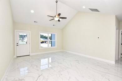 Tiled empty room with high vaulted ceiling and cei