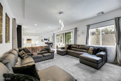 Carpeted living area with recessed lighting