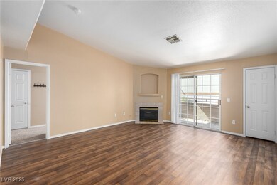 Unfurnished living room with a tile fireplace, vis