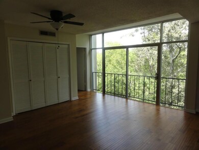 Wall of windows overlooks treetops on the park & r