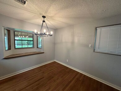 Spare room featuring a textured ceiling, visible v