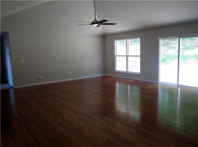 21x19 Great Room with hardwood flooring and cathedral ceiling