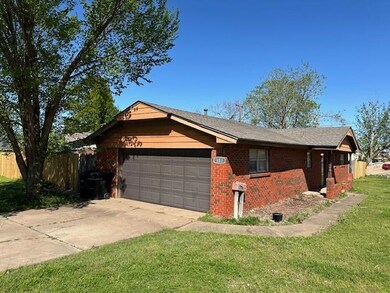 Ranch-style home with a front lawn and a garage