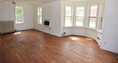 The living room has a unique sun area that lets ex