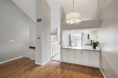 The kitchen has an island overhang of quartzite an