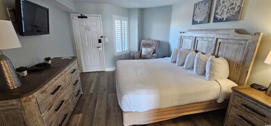 Bedroom with dark wood-type flooring