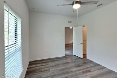 Unfurnished room featuring hardwood / wood-style f