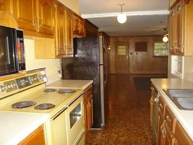 Kitchen Opens to Den/Family Room, with Broken Tile