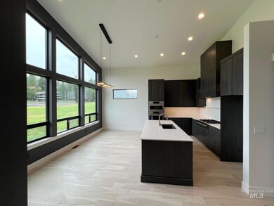 Kitchen featuring modern cabinets, healthy amount of natural light, light countertops, and recessed lighting