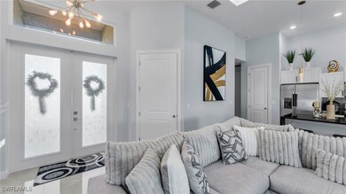Living room with a notable chandelier and french d