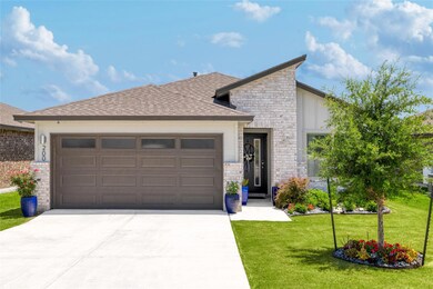 View of front of house with a garage, driveway, s