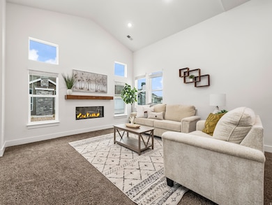 Living room with vaulted ceilings and fireplace.