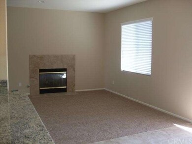 The family room has a cozy fireplace.  Can you see
