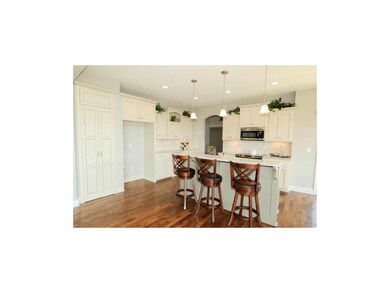 KITCHEN VIEW OF ISLAND WITH BREAKFAST BAR BELOW CO