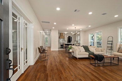 Stepping inside, you’re greeted by an open floor plan, restored original hardwood floors, recessed lighting, original door knobs, and a palette of neutral tones that create a warm and welcoming ambiance.