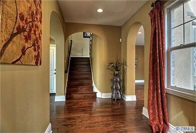 View from foyer to stairs to all bedrooms. Living 