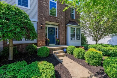 Professionally landscaped yard with sprinkler system and landscape lighting.