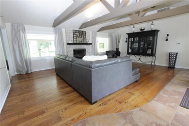 3 expansive exposed wood beams make for a stunning entry statement