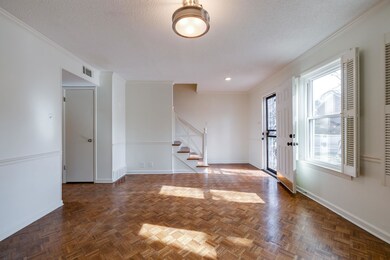 Foyer entrance with ornamental molding, dark parqu