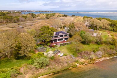 Panoramic view of the back of the home on the waterfront.