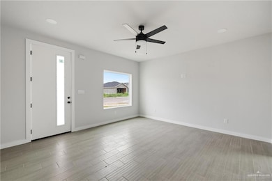 Entryway with a ceiling fan, wood finished floors, and recessed lighting