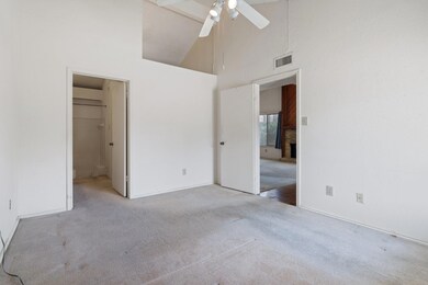 Unfurnished bedroom with high vaulted ceiling, vis