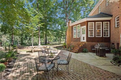 The large side patio offers views of the trees and