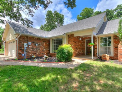 Ranch-style home with brick siding, a front yard, roof with shingles, and a garage