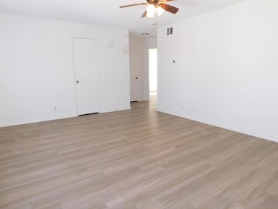 Unfurnished room with baseboards, visible vents, 