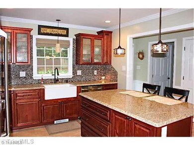Kitchen. Kitchen island, beautiful new sink, this room is completely remodeled. The cabinets have soft close drawers and the microwave is in the island.