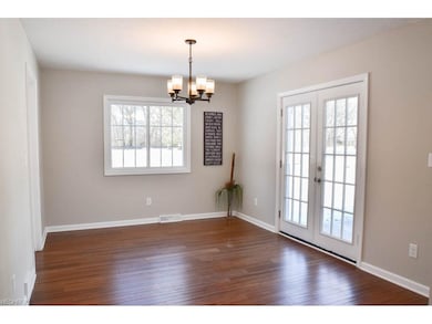 Dining room with bamboo flooring and patio access.