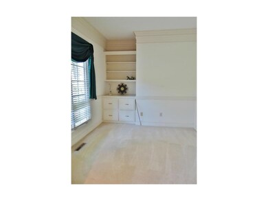 The office offers crown molding, a large window & 