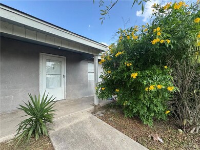 Entrance to property with stucco siding