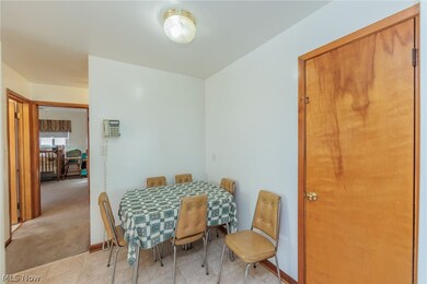 Dining area featuring light carpet