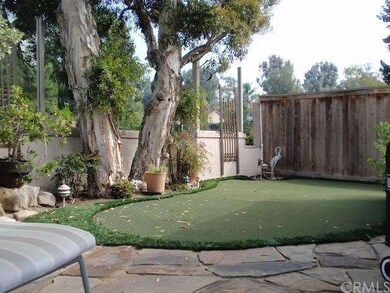Backyard with artificial turf putting green and st