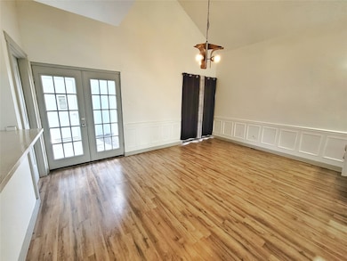 Natural light extends through the dining area that opens to the kitchen area