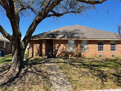 View of front of house featuring brick siding, a f