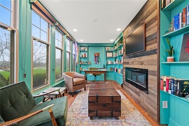 Living room with hardwood / wood-style flooring and a tiled fireplace