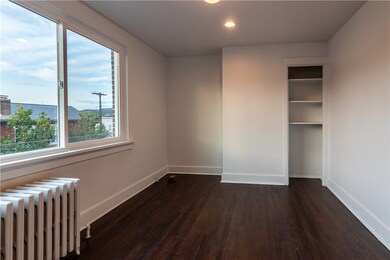 Bedroom 1 with original hard wood floors, built in