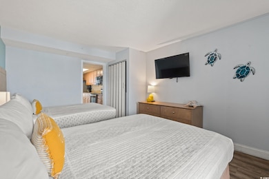 Bedroom featuring wood finished floors and baseboards