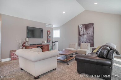 Carpeted living room w/ custom lighting