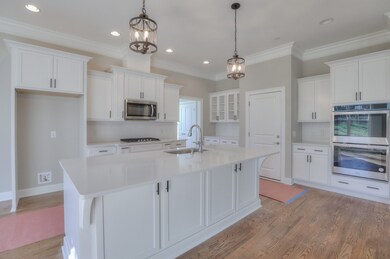 Wonderful kitchen with quartz counters. Double ovens, gas cooktop, oversized island with additional storage.