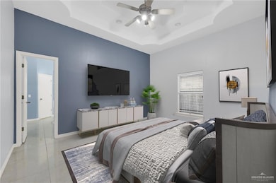 Bedroom with a raised ceiling, light tile patterned floors, and ceiling fan