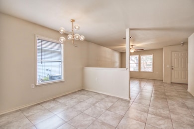 Spare room featuring ceiling fan, light tile patt