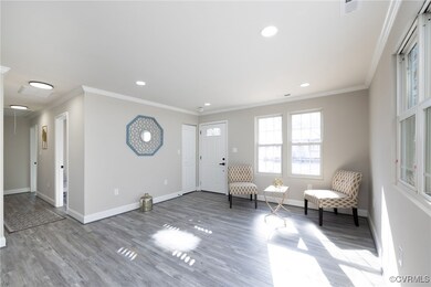 Unfurnished room with crown molding and hardwood /