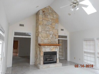 Large vaulted ceiling Sunroom with stone fireplace