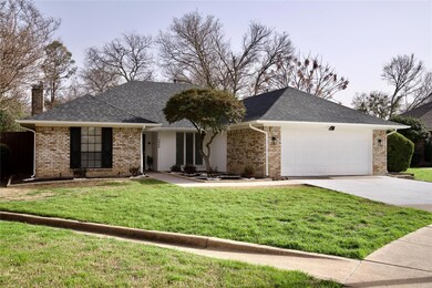Ranch-style house featuring a garage, driveway, br