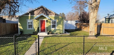 Bungalow-style house with a gate and a fenced front yard
